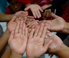 Photograph of glitter on the hands, showing how contamination can spread